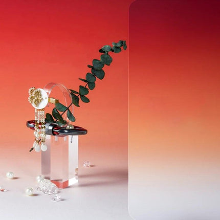 Gradient Background Paper for Portrait Photography, 106x144cm showcasing jewelry and eucalyptus on a smooth red-to-white gradient backdrop