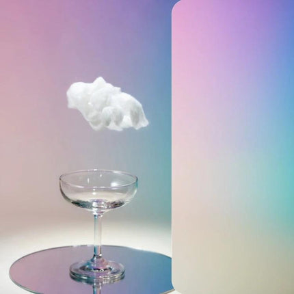 Gradient Background Paper for Portrait Photography, 106x144cm showing pastel gradient backdrop with floating cotton cloud and glass on reflective disc
