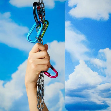 Gradient Background Paper for Portrait Photography, 106x144cm showing hand gripping chain with colorful carabiners against sky gradient backdrop