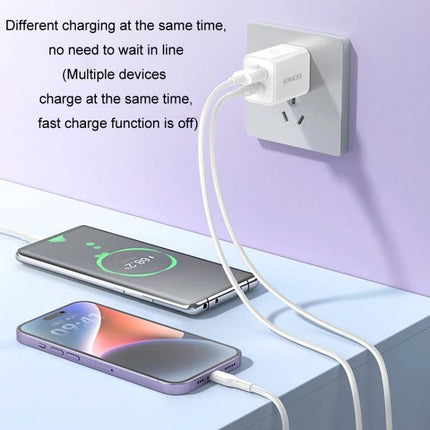 ROMOSS Charger for Daily Phone Use at Home or Travel plugged into wall charging two smartphones on a desk
