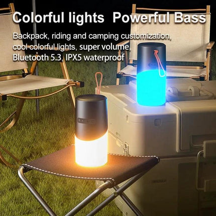 Bluetooth Speaker With Ambient Mood Lighting For Home Use shown glowing blue and orange at an outdoor camping setup