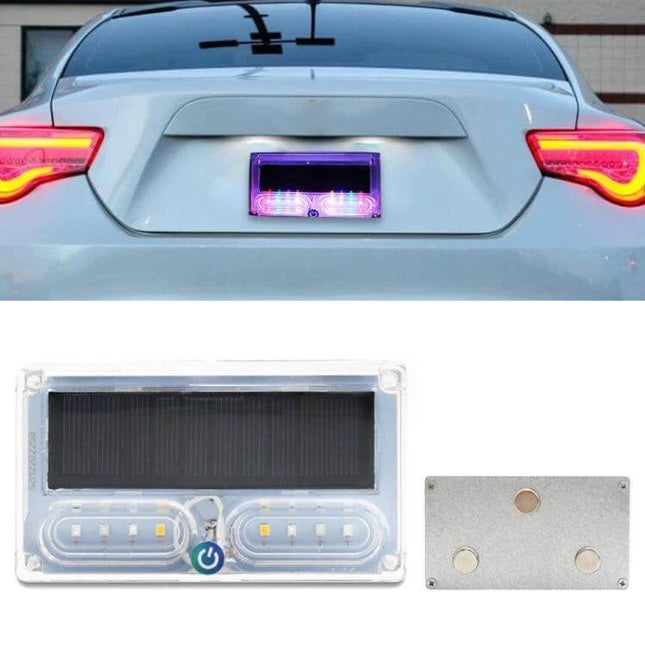 Car Solar Warning Light for Rear LED Tail Light All Weather mounted on sedan rear near license plate, solar panel and bright LEDs visible
