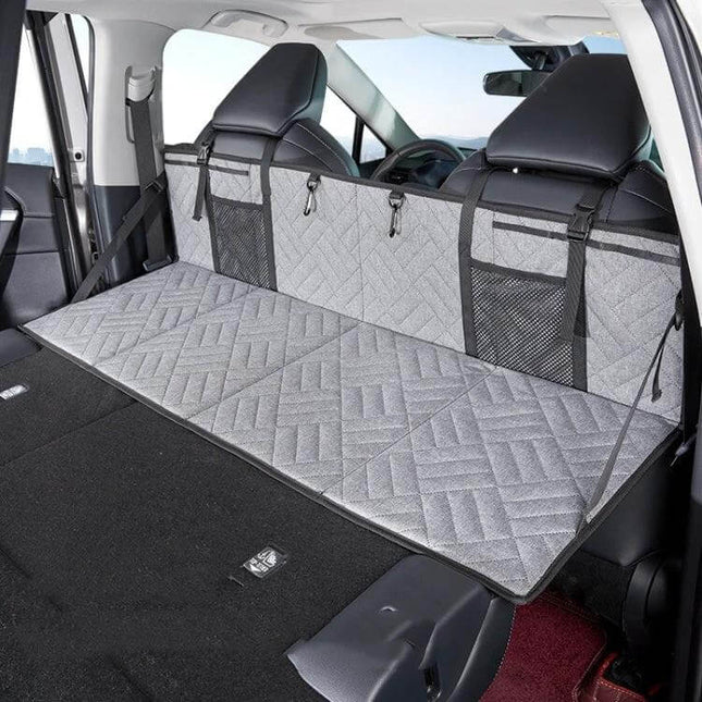 Car Camping Bed Folding Board For SUV Rear Row Gray Embossed shown set up flat in SUV rear with quilted gray surface and mesh storage pockets
