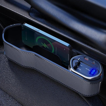 Digital Display Multifunctional Car Seat Gap Storage Box With Wireless Charging shown in car between seats with phone charging and cup organizer