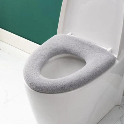 Cozy Knitted Toilet Cover for Daily Home Comfort on white toilet seat, soft gray knit, easy-fit for warmer bathroom mornings