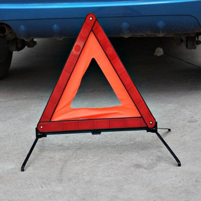 Foldable Reflective Emergency Warning Triangle for Vehicles set up behind a car on pavement for roadside safety