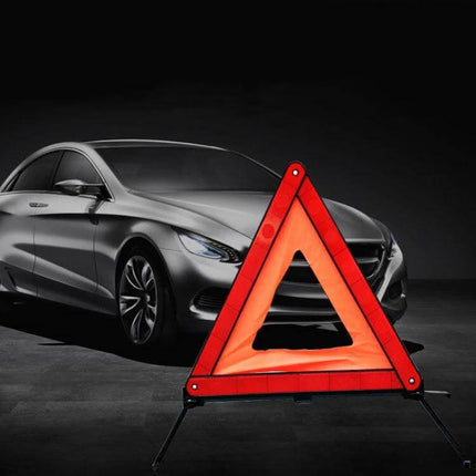 Foldable Reflective Emergency Warning Triangle for Vehicles set up in front of a parked car for roadside safety