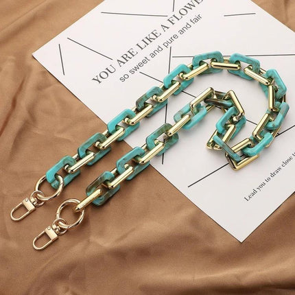 Retro Tortoiseshell Acrylic Phone Lanyard for Hands-Free Use turquoise tortoiseshell acrylic chain with gold hardware shown on fabric background