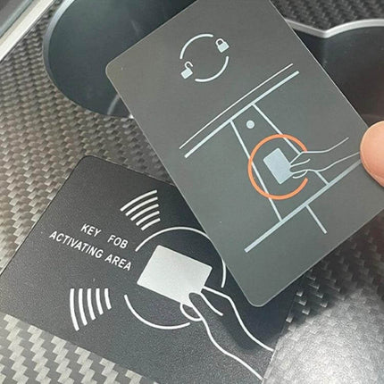Tesla Center Panel Protection Film Matte Carbon Fiber on Tesla cupholder showing matte carbon fiber texture and key activation cards