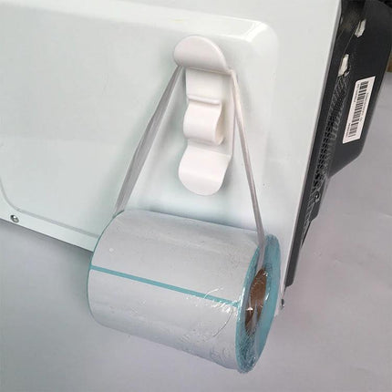 Kitchen Cord Organizer for Daily Appliance Storage on microwave side holding plastic wrap roll to keep cords and counters tidy