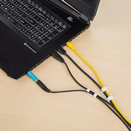 Set of 20 Adhesive Cable Clips for Home Wire Organization securing laptop cables on desk to keep cords tidy and tangle-free