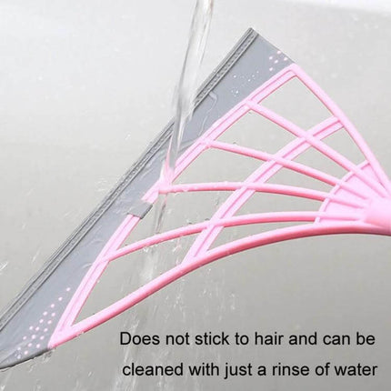 Magic Broom Soft Silicone Scraper Bathroom Wiper For Daily Cleanup - pink silicone scraper rinsed under running water, flexible low-profile head removes water and hair