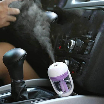 Car Negative Ion Humidifier For Aromatherapy In The Car placed in console emitting mist and improving cabin air quality