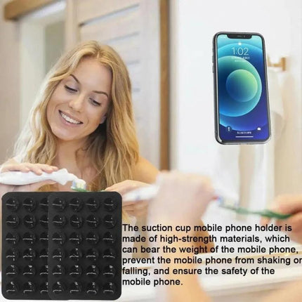 Square Silicone Suction Cup Stickers for Phone Mounting Surfaces shown holding phone on mirror while woman brushes teeth