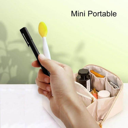 Silicone Nose Cleaning Brush Double-Sided Pore Cleansing compact portable yellow silicone brush held over makeup pouch