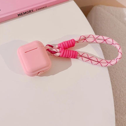 Protect Your AirPods During Daily Activities With Silicone Cover — pink silicone AirPods case with braided pink wrist strap