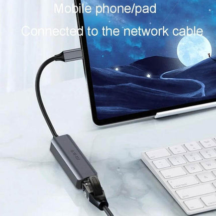 JINGHUA Gigabit LAN Converter for Computer Network Connections connected to tablet via USB-C providing stable wired Ethernet for streaming and gaming