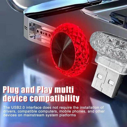 Mushroom USB Ambient Light For Car And Home Ice Blue plugged into USB port glowing red on car dashboard and USB drive nearby