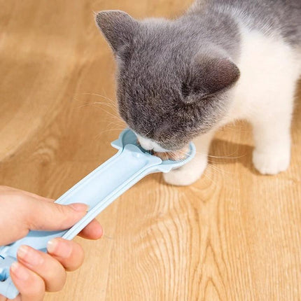 Spoon for Everyday Cat Feeding and Snack Giving at Home being used to feed a gray and white cat a measured treat