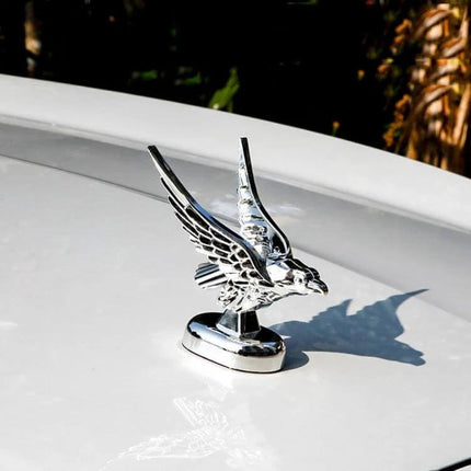 Universal 3D Spread Wings Flying Eagle Car Hood Emblem mounted on white car hood, chrome ABS plastic detailed eagle ornament