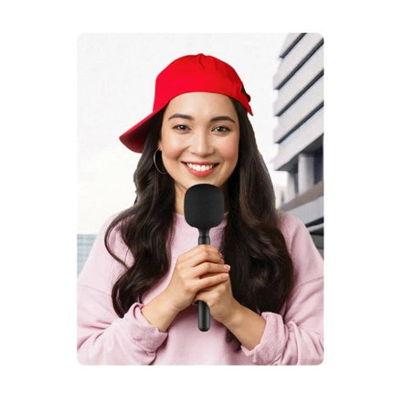 Handheld Microphone Accessory for Everyday Interviews and Vlogging held by smiling vlogger with red cap, lightweight handle for field interviews and reduced wind noise