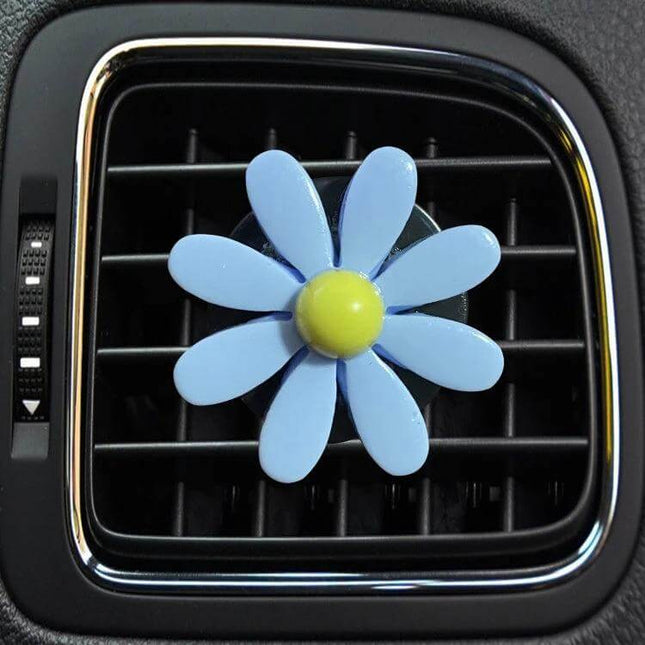 Colorful Daisy Car Decorative Air Vent Aromatherapy Clip Blue shown clipped to car vent, blue daisy with yellow center for subtle cabin fragrance