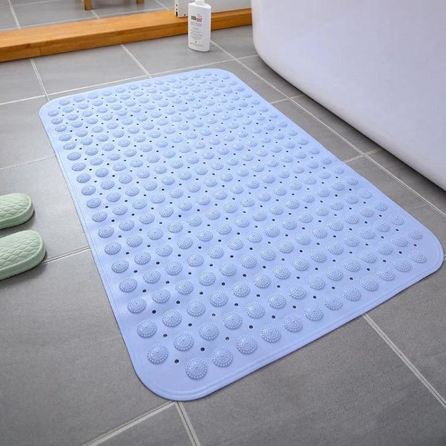 Essential Bathroom Mat for Everyday Home Wet Area Use - non-slip blue bathroom mat with suction dots placed beside bathtub on tiled floor