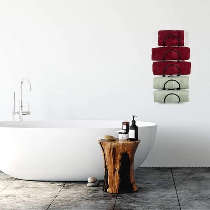 Wall Mounted Shelf for Organizing Bathroom Essentials Daily showing wrought iron shelf holding folded towels above bathtub, saving floor space