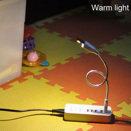 Compact USB Light for Emergency Use During Travel and Home glowing warm light plugged into USB hub on foam play mat, portable travel emergency illumination