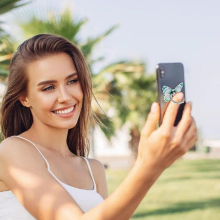 Cartoon Butterfly Phone Ring Holder for Easy Viewing and Grip on smartphone used for taking a selfie outdoors