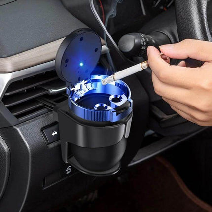 Car Air Conditioner Outlet Cup Holder Ashtray With Adjustable Clamp shown mounted on car vent with LED light and cigarette being ashtray