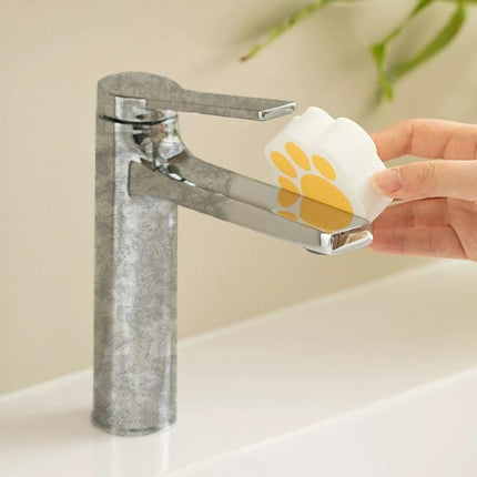 Sponge for Daily Bathroom Mirror and Faucet Cleaning used to wipe water spots from a chrome faucet