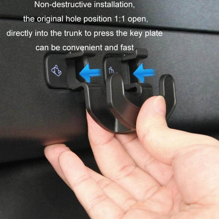 Tesla Model Y Trunk Seat Button Hook For Extra Hanging Space shown snapped into trunk button panel holding grocery bags
