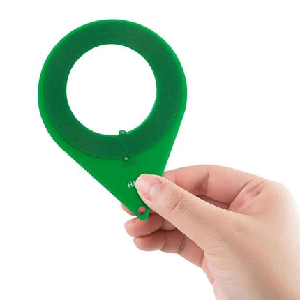 Essential Card for Routine Car Lock System Checks - green plastic ring tester held in hand for anti-theft sensor check