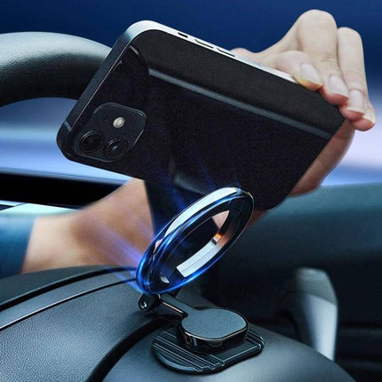 Magnetic Folding Car Phone Holder Rotatable Steering Wheel Mount attached to dashboard steering wheel showing phone being placed on circular magnetic mount
