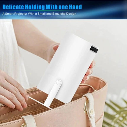 Portable Smart Projector with Android for Home Streaming shown compact being placed into a handbag, highlighting portable design and built-in connectivity
