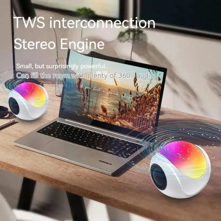 Portable Bluetooth Speaker Compact For Home And Travel Use showing two colorful spherical speakers paired stereo beside laptop
