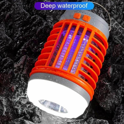 E SMARTER Outdoor Solar Mosquito Light Trap For Yard And Patio shown lit with violet UV insect attractant and white ambient light, waterproof orange casing