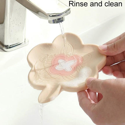 Practical Silicone Soap Dispenser for Everyday Bathroom Routines - beige flower-shaped soap holder draining and rinsing under faucet