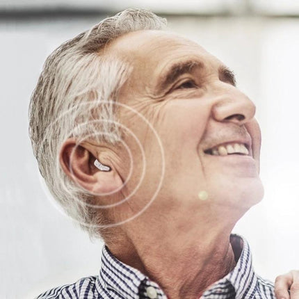Invisible In-Ear Hearing Aid for Elderly with Sound Amplification shown discreetly fitted in smiling elderly man’s ear enhancing conversation and TV audio
