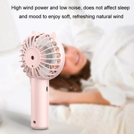 Portable Rechargeable Mini Handheld Fan with Phone Holder for Desktop Use - pink handheld fan shown near sleeping person for quiet desk cooling