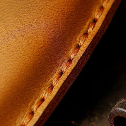 Key Cover For Motorcycle Brown Hollowed Daily Use close-up of brown cowhide stitching and leather texture protecting motorcycle key