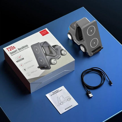 Forklift-Shaped Charger for Daily Desk Device Setup on a desk with box, USB cable and manual, showing phone and smartwatch charging areas