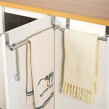 Stainless Steel Towel Rack For Kitchen Cabinet Storage mounted on cabinet door holding two beige hand towels
