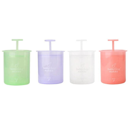Portable Foaming Cup for Daily Skincare and Travel Use - four pastel travel foaming cups in green, purple, clear, and coral for quick foam cleansing