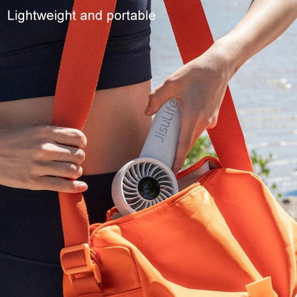 JisuLife Life4 Rechargeable Handheld Fan for Daily Cooling - compact, lightweight fan being placed into an orange bag for portable everyday use