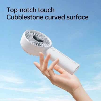 JisuLife Life4 Rechargeable Handheld Fan for Daily Cooling compact white handheld fan in hand with curved cobblestone surface against blue sky