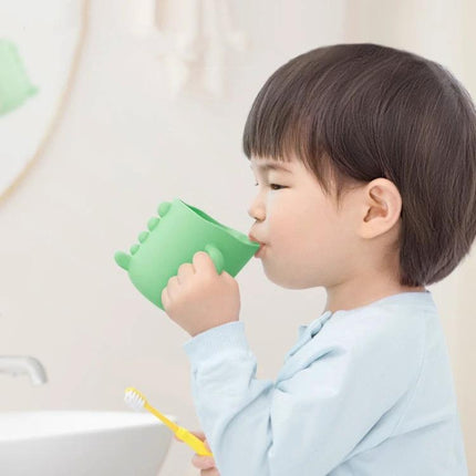Cute Dinosaur Cup for Baby's Daily Home Hydration showing toddler drinking from green dinosaur cup with easy-grip design and spill-resistant spout