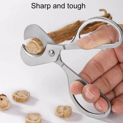 Portable Pill Cutter With Stainless Steel Blades, Oval Handle showing stainless steel scissors cutting a ginseng tablet for travel and home use