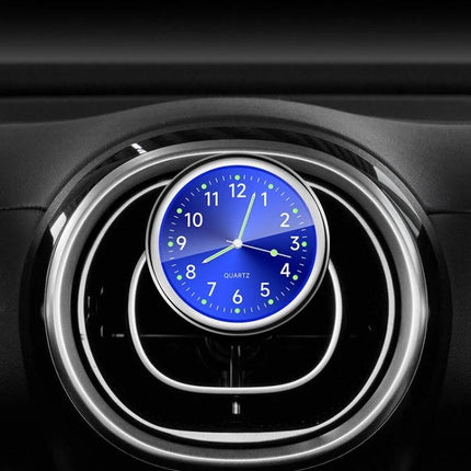 An Essential Luminous Clock for Everyday Car Drives mounted on car vent showing glowing blue luminous dial for easy night-time time checks